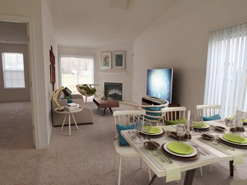 A dining room with a table set for a meal.