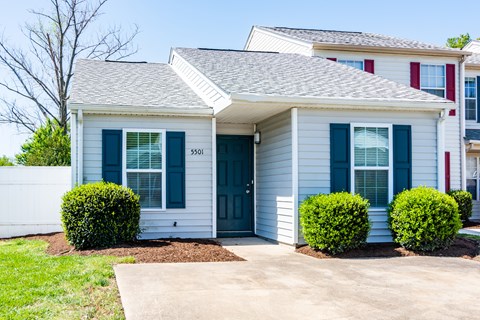 A house with a blue door and windows.