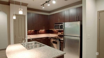 Kitchen showing the island, cabinets, and appliances - Photo Gallery 4