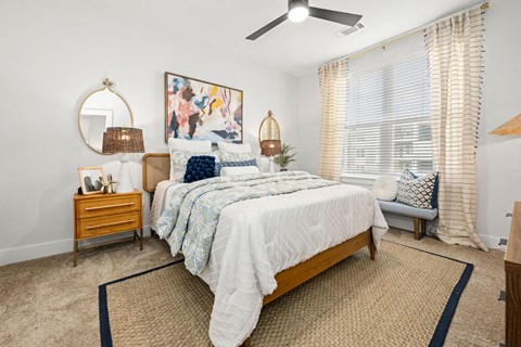 a bedroom with a bed and a ceiling fan