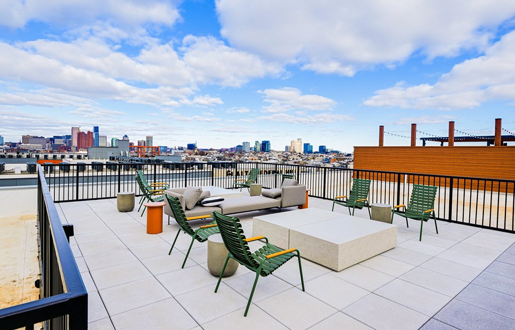 A rooftop patio with a view of the city skyline.