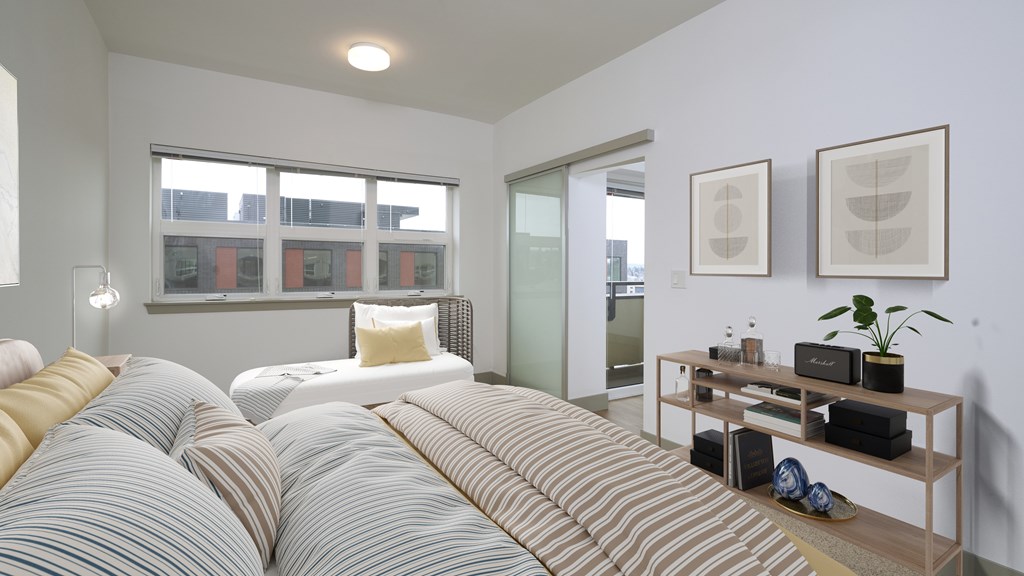 A bedroom with a large bed and a wooden table with a plant on it.