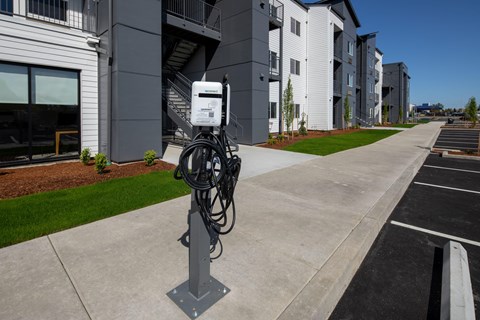 Parking lot with a charging station for electric vehicles at The Arvon, Vancouver