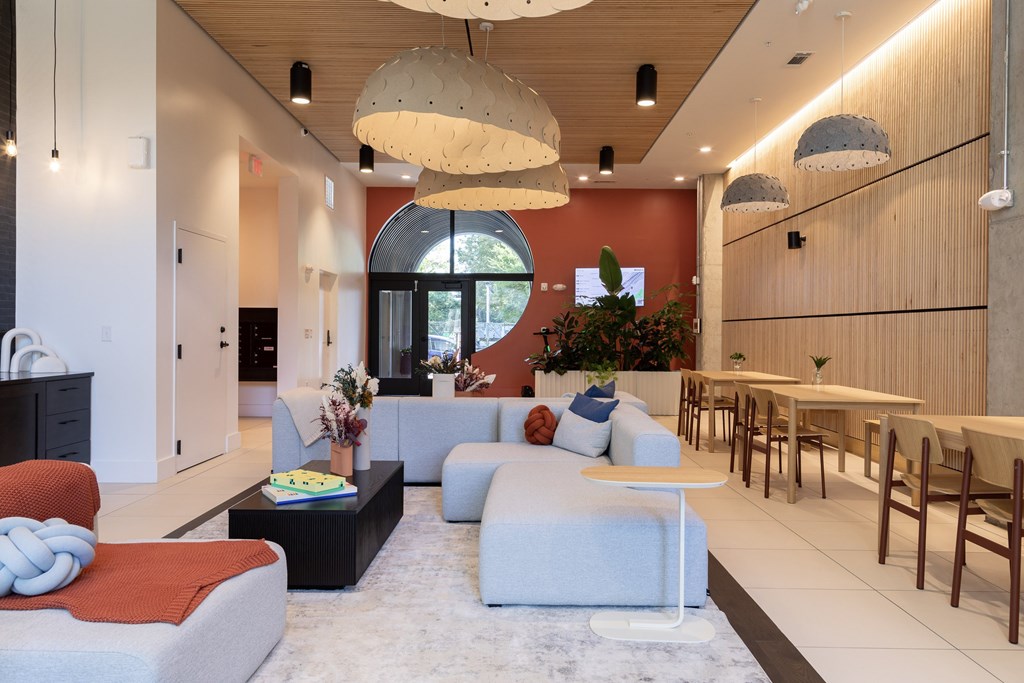 A modern living room with a grey sofa and a coffee table.