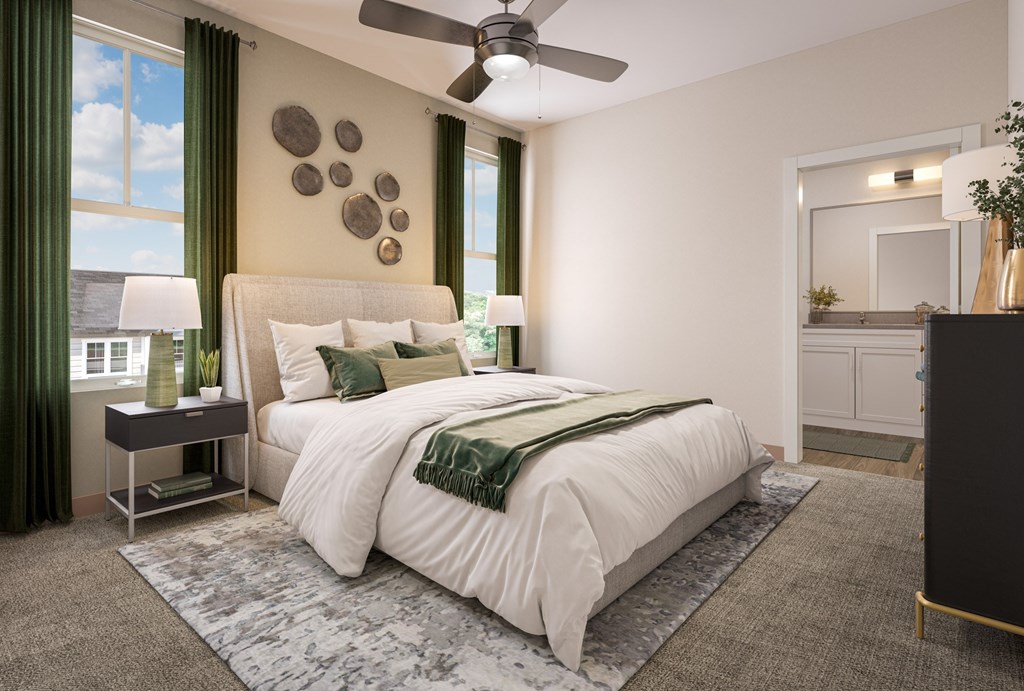 A bedroom with a large bed and a ceiling fan.