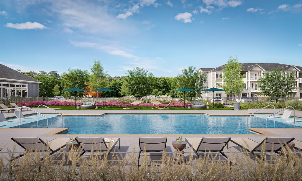 A pool surrounded by chairs and trees at Easton at Mountain Island apartments in Charlotte, NC.