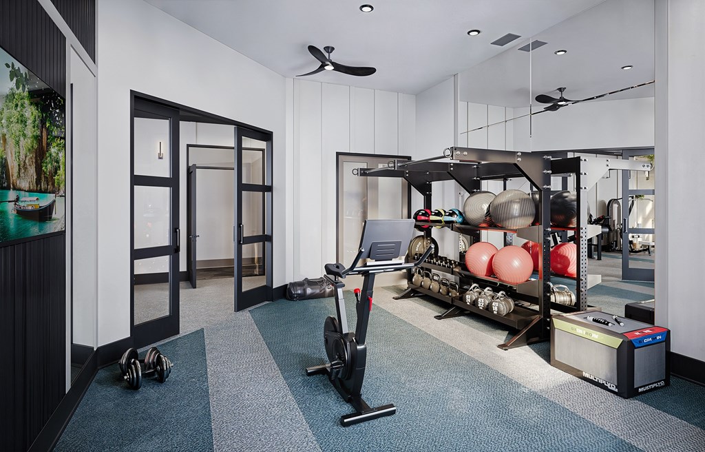 A room with a treadmill and a fan at Easton at Mountain Island apartments in Charlotte, NC.