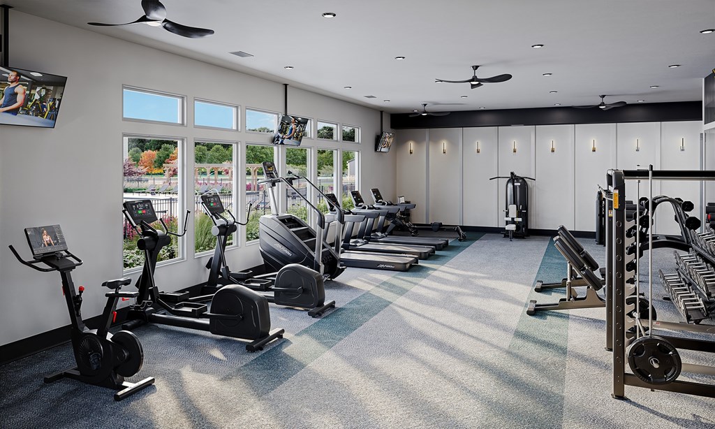 A gym with a variety of equipment including treadmills, elliptical machines, and weight machines at Easton at Mountain Island new apartments in Charlotte, NC.
