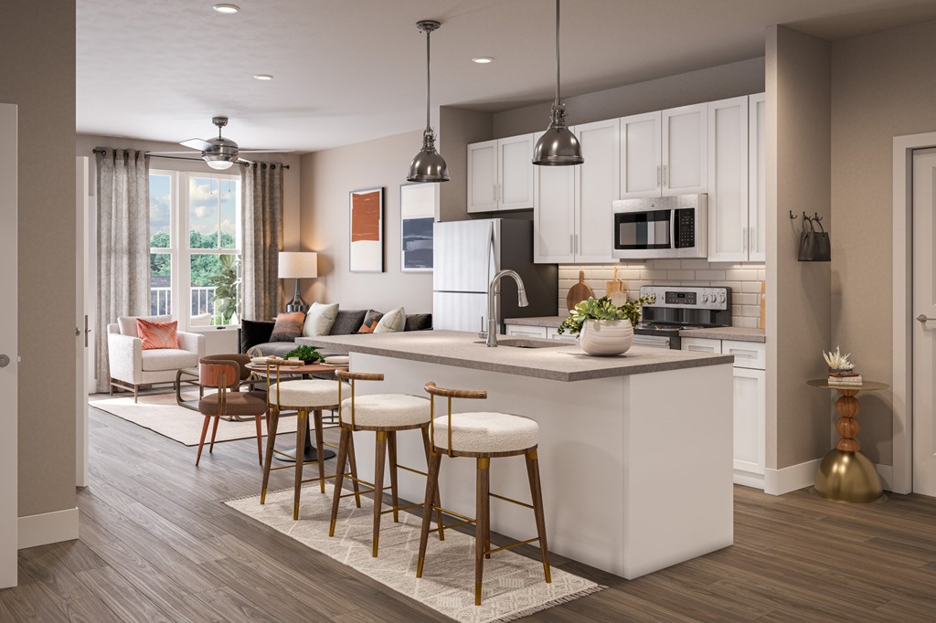 A modern kitchen with white cabinets and a large island at Easton at Mountain Island apartments in Charlotte, NC.