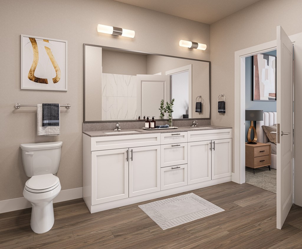 A bathroom with a toilet, sink, and mirror.