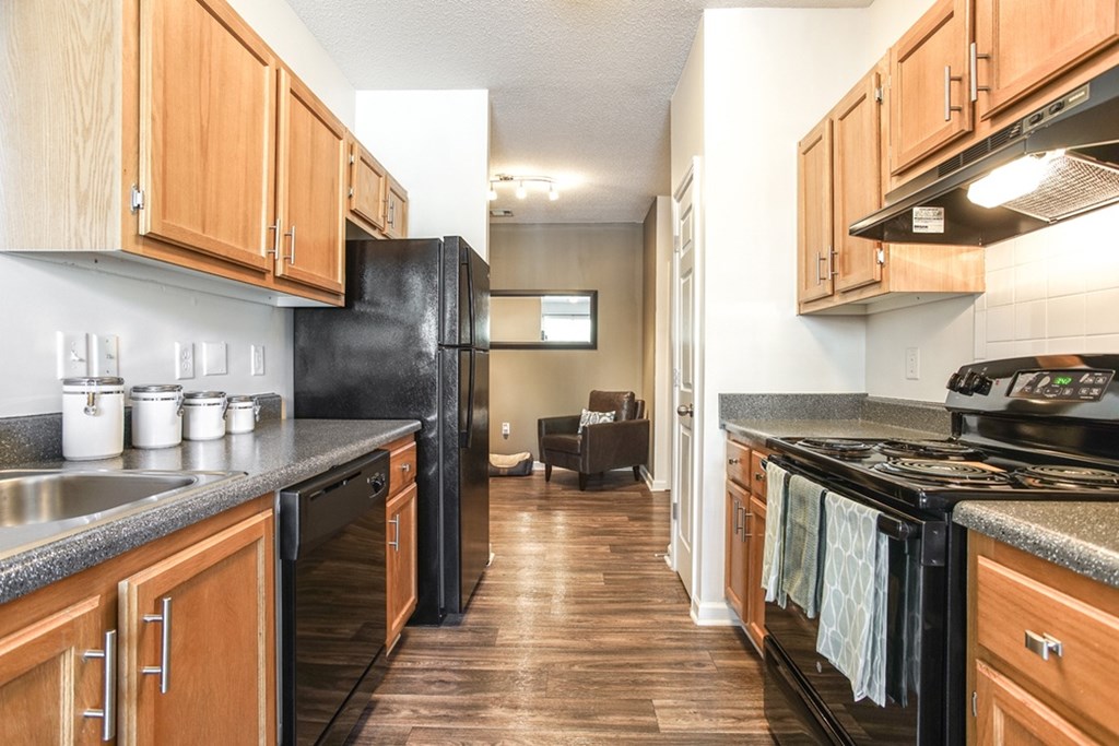 Kitchen with wood cabinets and granite counters at Eastwood Village apartments in Stockbridge, GA.