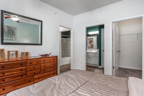 A bedroom with a dresser and a mirror.