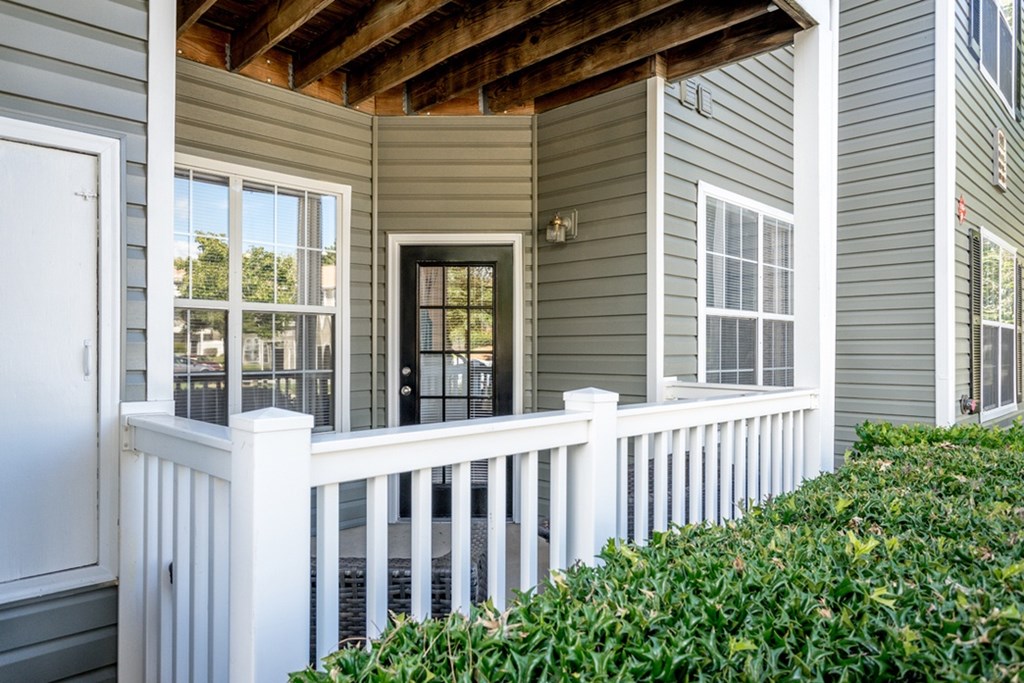 A house with a white fence and a black door.