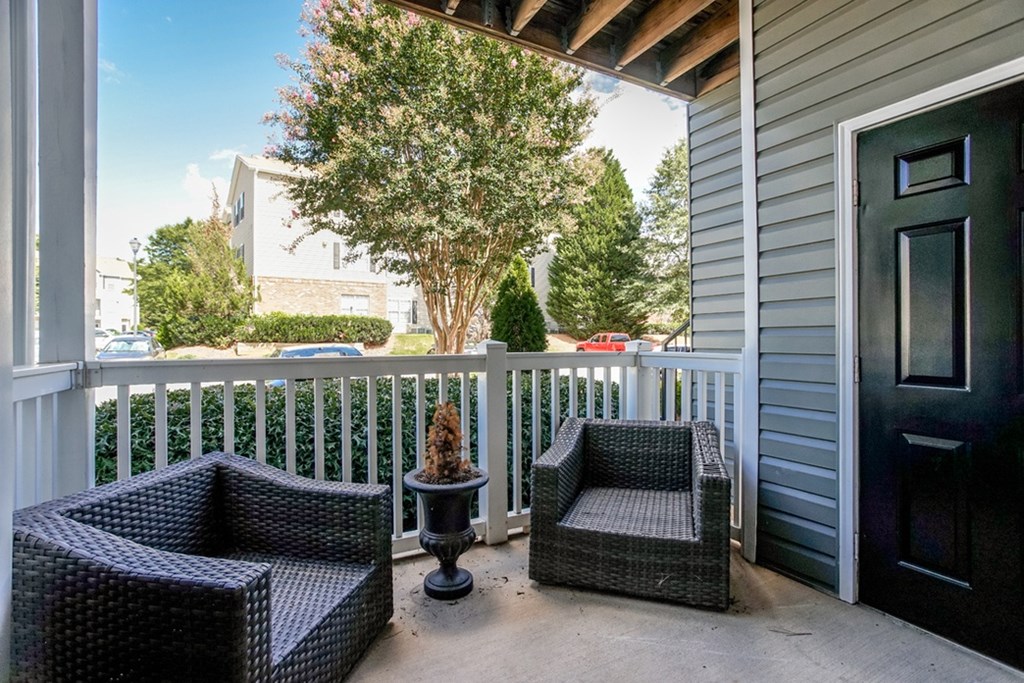 Patio with two chairs and a table at Eastwood Village Stockbridge apartments.