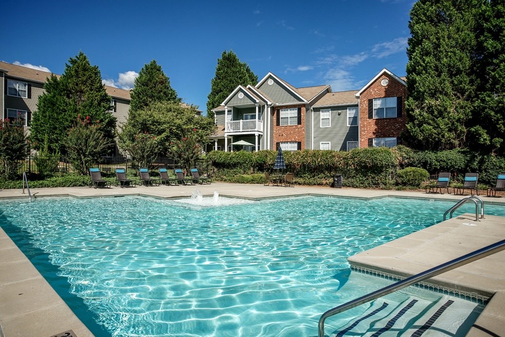 Large swimming pool with trees at Eastwood Village Stockbridge apartments.