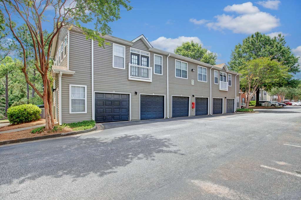 A row of townhouses with garages on the side.