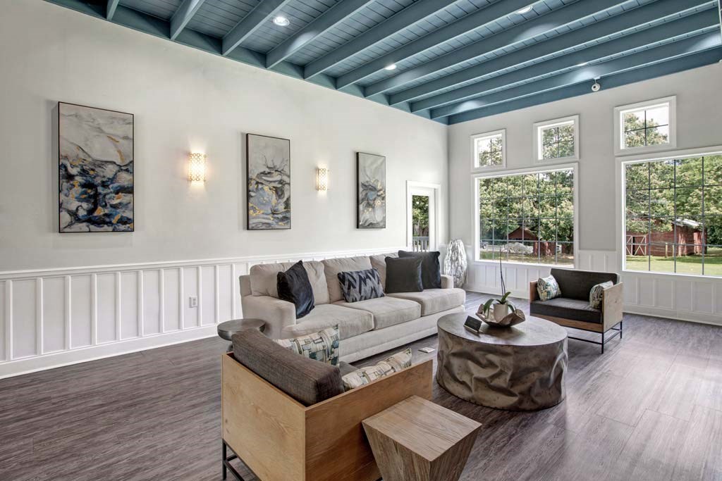 A bright living room with sofa at Eastwood Village Stockbridge apartments.
