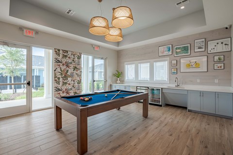 a game room with a pool table and a window