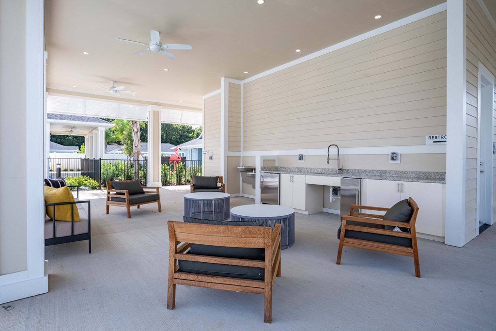 a patio with a table and chairs and a kitchen