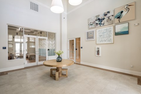 a dining room with a table and paintings on the wall