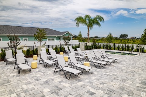the pool area at the preserve at ballantyne commons with chaise lounge chairs