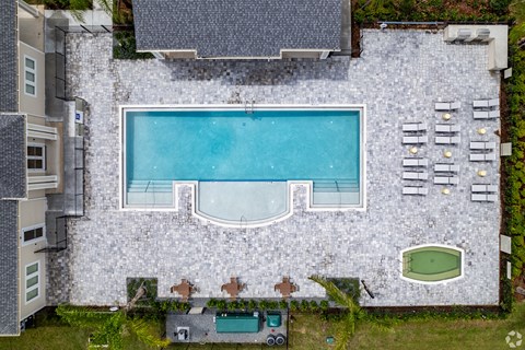 a birds eye view of a pool in the backyard of a house