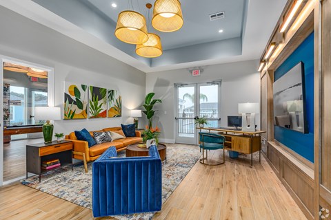 a living room with couches and chairs and a desk