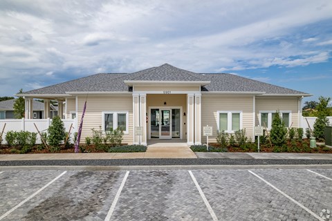 a large white house with a driveway and a front door