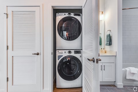 a white washer and dryer in a small laundry room
