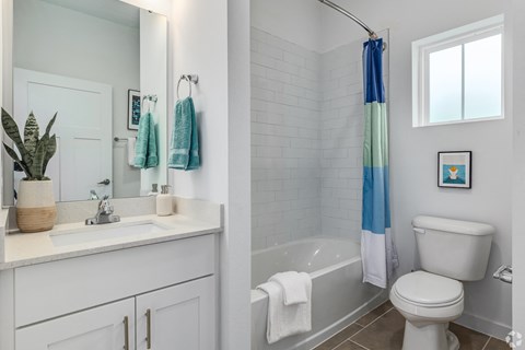 two views of a bathroom with a toilet sink and tub