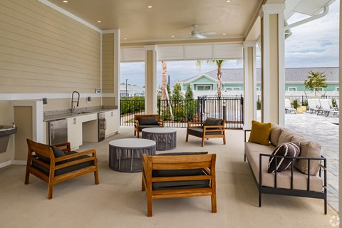 a living room with a kitchen and a patio