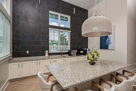 a kitchen with a granite counter top and a table with chairs