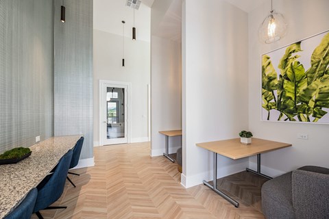 a dining room with a table and chairs and a hallway with a door