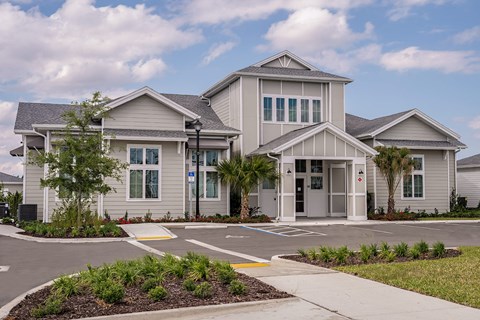 the exterior of a home with a parking lot and sidewalks
