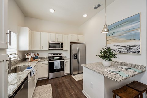 a kitchen with stainless steel appliances and granite counter tops
