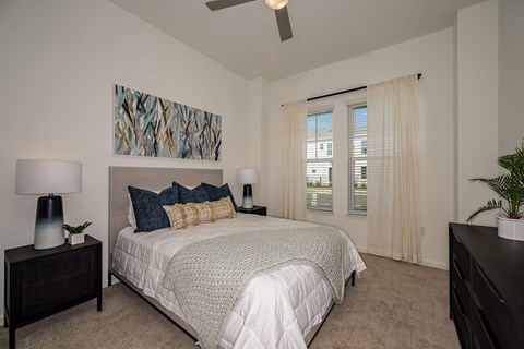 a bedroom with a large bed and a ceiling fan