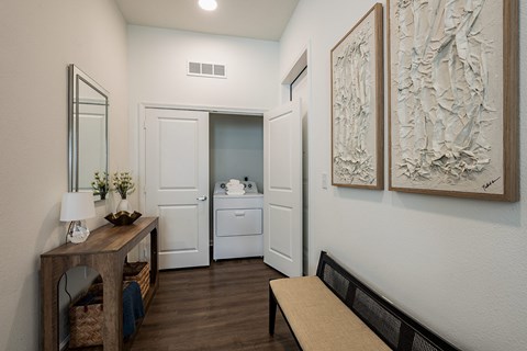 a living room with a desk and a door to a bathroom
