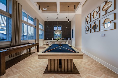 a billiards room with a pool table and a bar