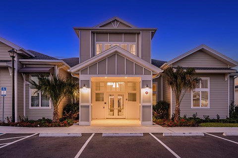 a house with a white door in a parking lot