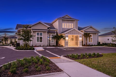a house with a street and sidewalk in front of it