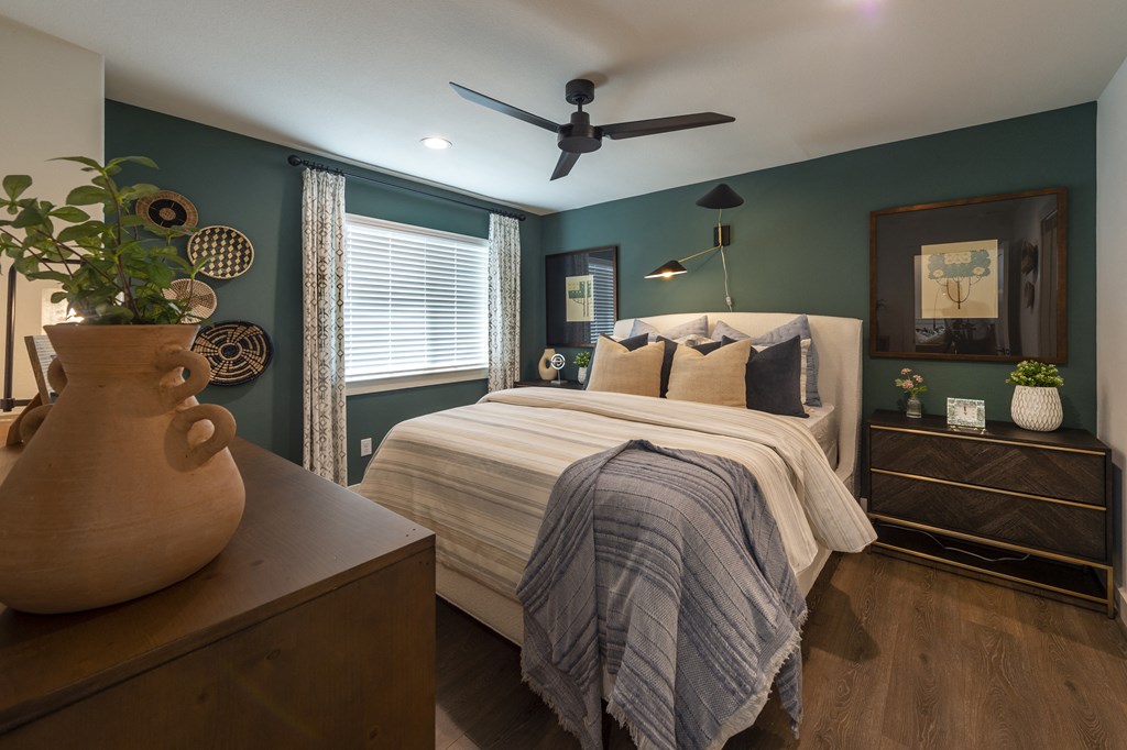 a bedroom with a bed and a ceiling fan