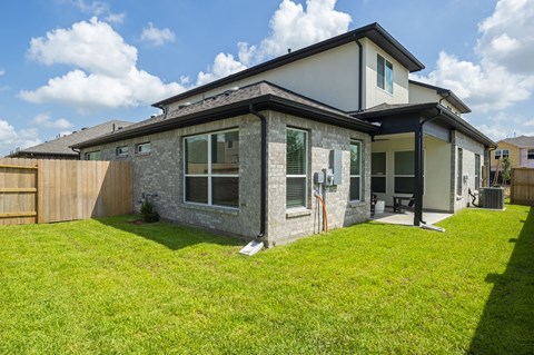 a view of a house with a lawn and a fence