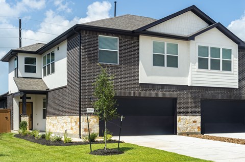 a house with a garage door in front of it