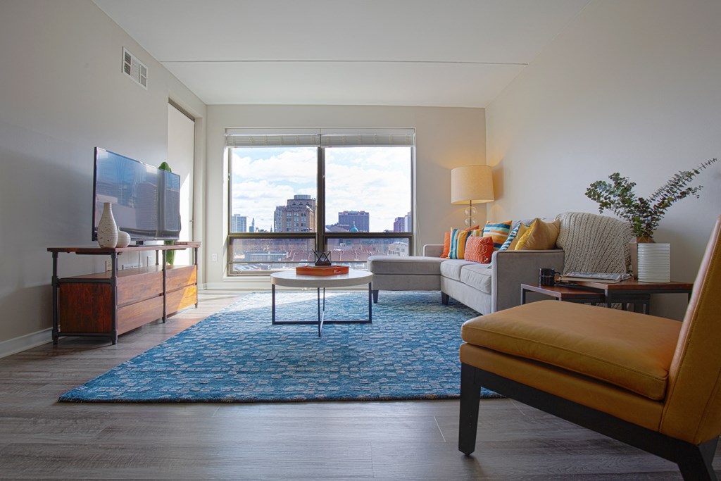 a living room with a large window and a view of the city