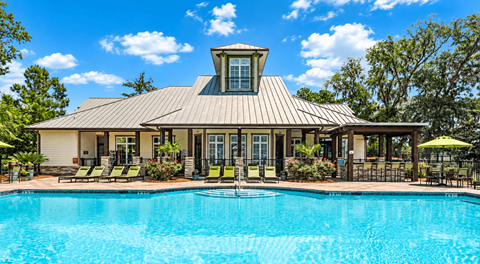 A house with a pool in front of it.