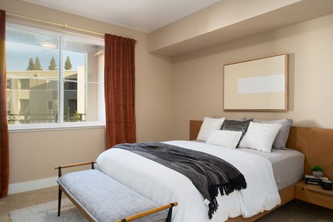 a bedroom with a bed and a window