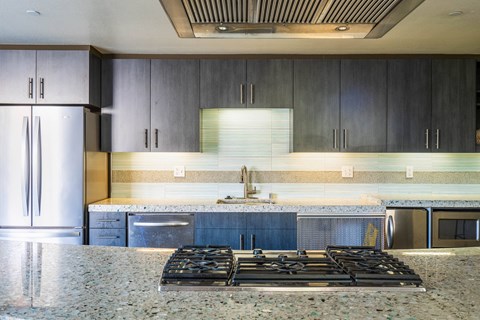 a kitchen with granite counter tops and stainless steel appliances