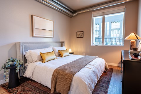 a bedroom with a bed and a window