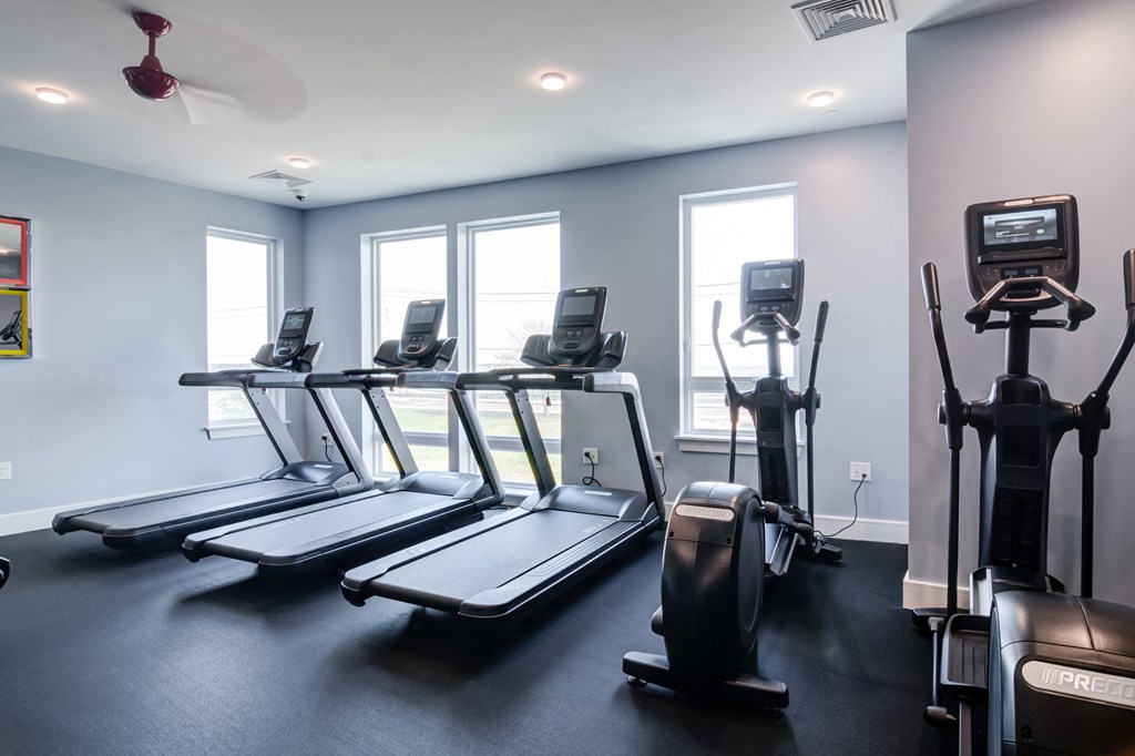 a gym with treadmills and other exercise equipment