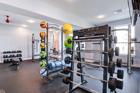 a fitness room with weights and a large window